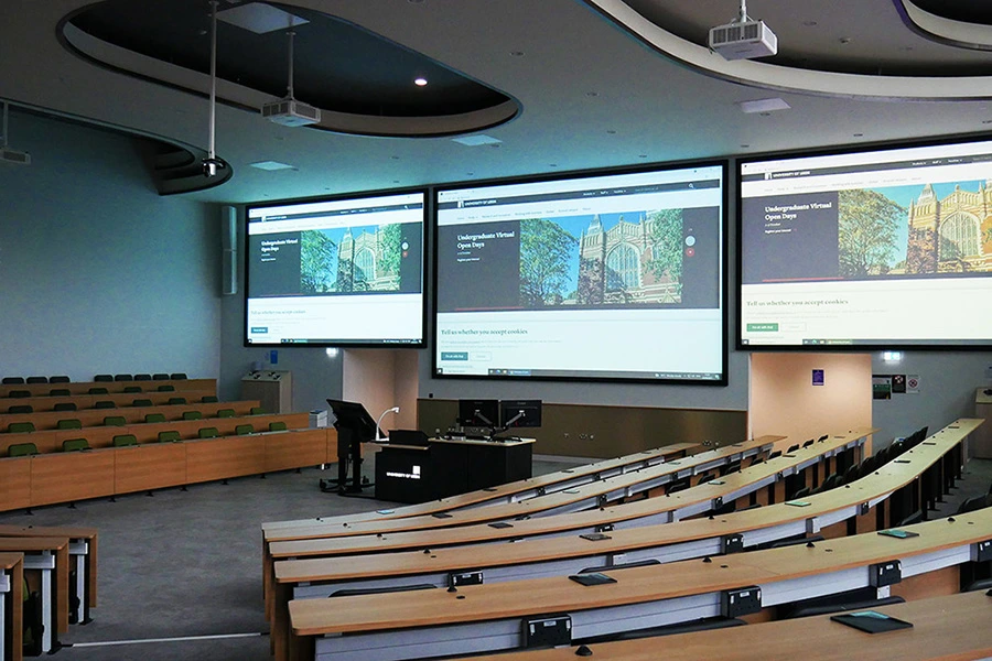 Display screen in a university auditorium for lectures and presentations.