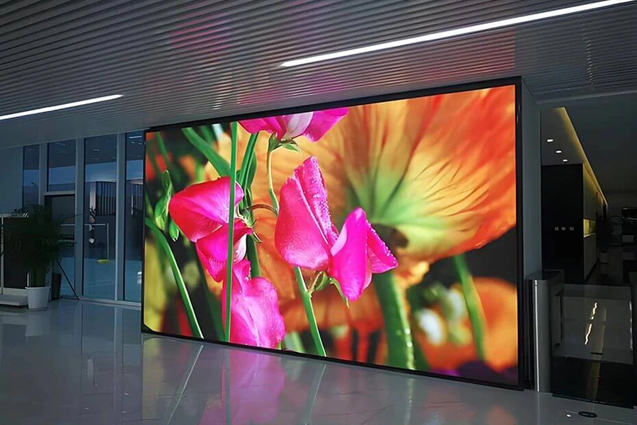 Indoor LED display showing high-resolution flower visuals in a modern space.