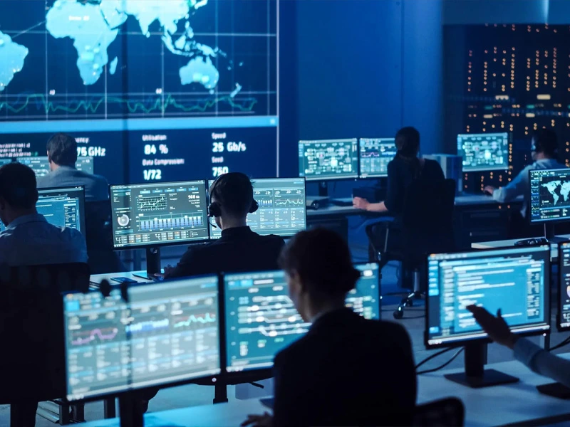 Modern command center with multiple LED displays showing real-time data, analytics, and monitoring dashboards.