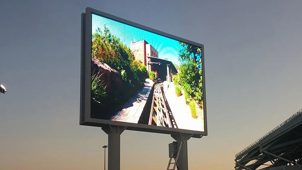 High-resolution outdoor LED display showing vibrant visuals during dusk at an open venue.