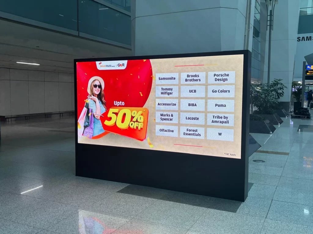 Outdoor digital display screen in India showing a sale promotion for retail stores.