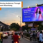 Digital billboard advertising display on busy Indian city road with bright LED outdoor screen view