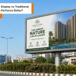 LED wall outdoor display showing a real estate advertisement on a busy urban road during daytime in India