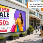 Modern LED wall board displaying a promotional sale advertisement outside an Indian commercial shopping complex during daytime.