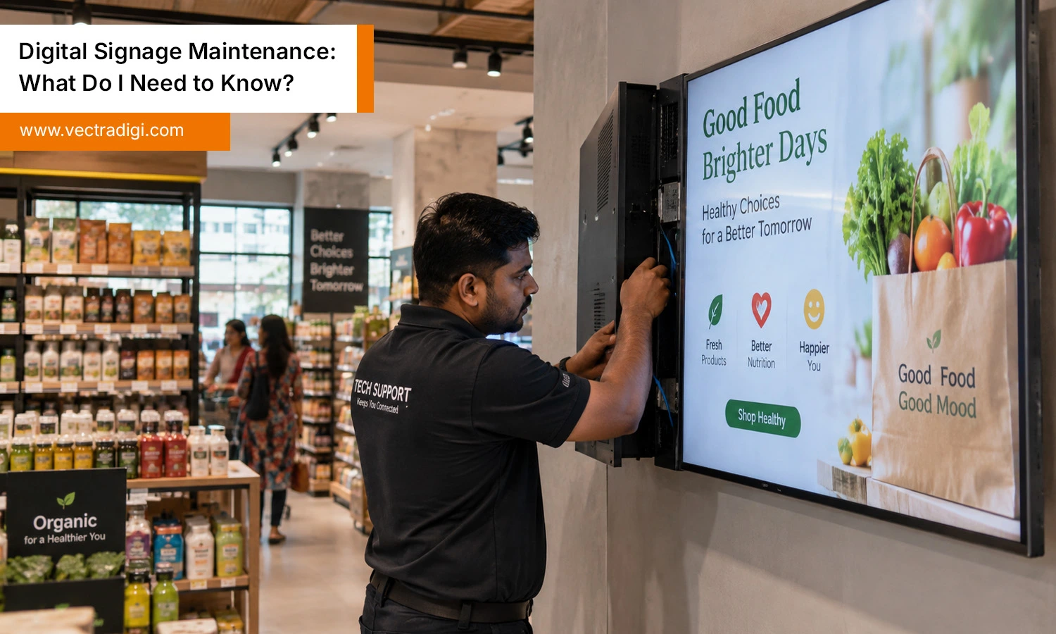 Indian technician performing digital signage maintenance on a display in a modern retail store.